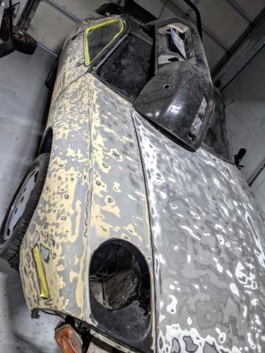 At some point it looks like the passenger door and fender were replaced based on two different primer colors
